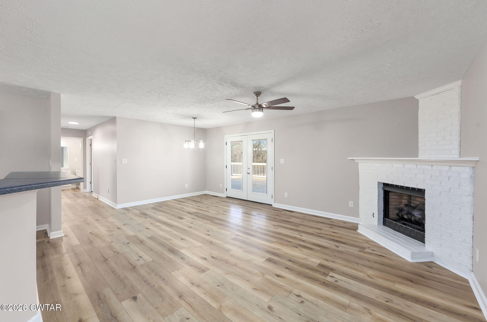 2265 Bond Ferry Road Brownsville, TN 38012 - Photo 21 of 26 a view of empty room with wooden floor and fireplace