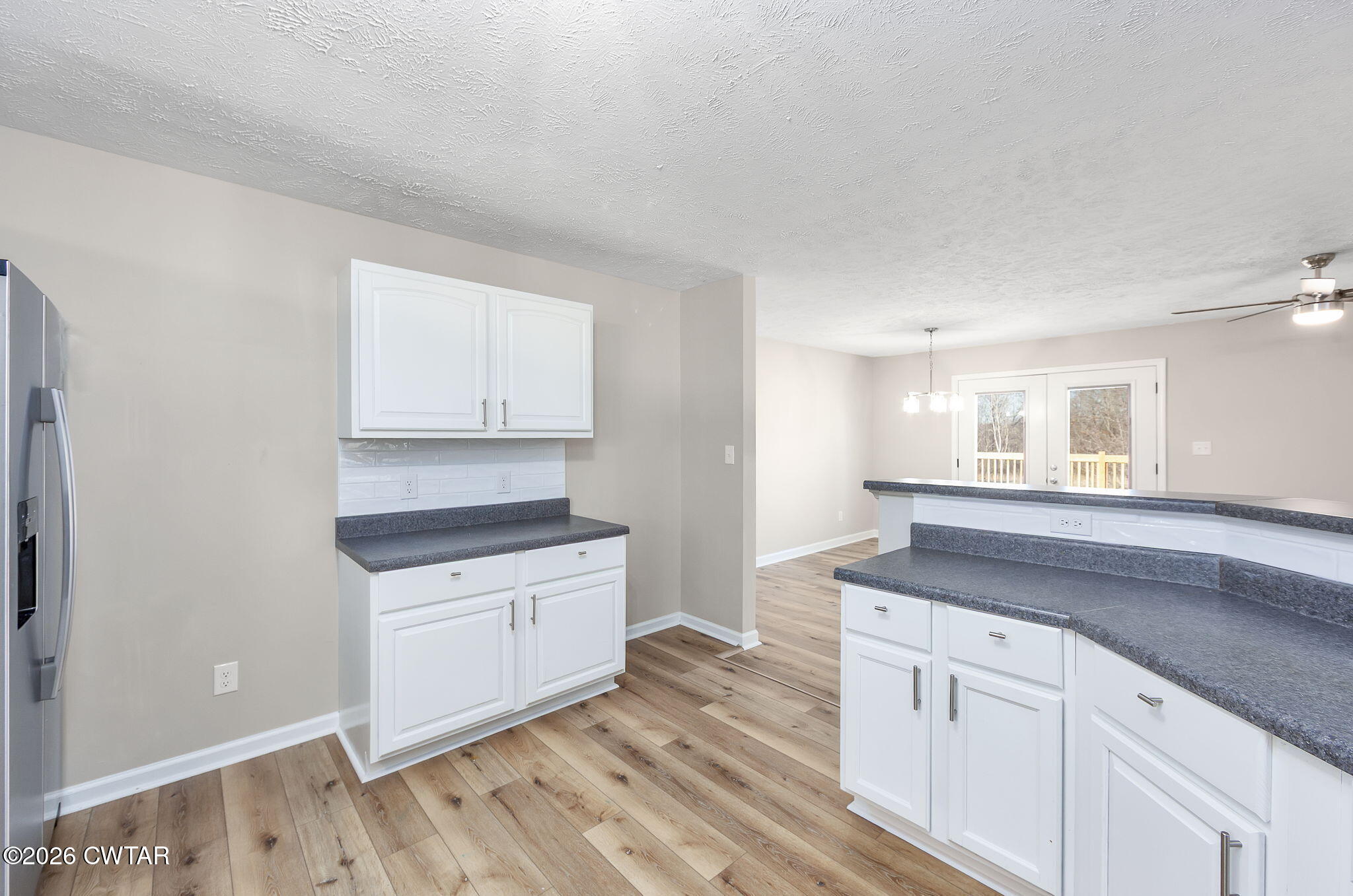 2265 Bond Ferry Road Brownsville, TN 38012 - Photo 23 of 26 a kitchen with granite countertop white cabinets and white appliances