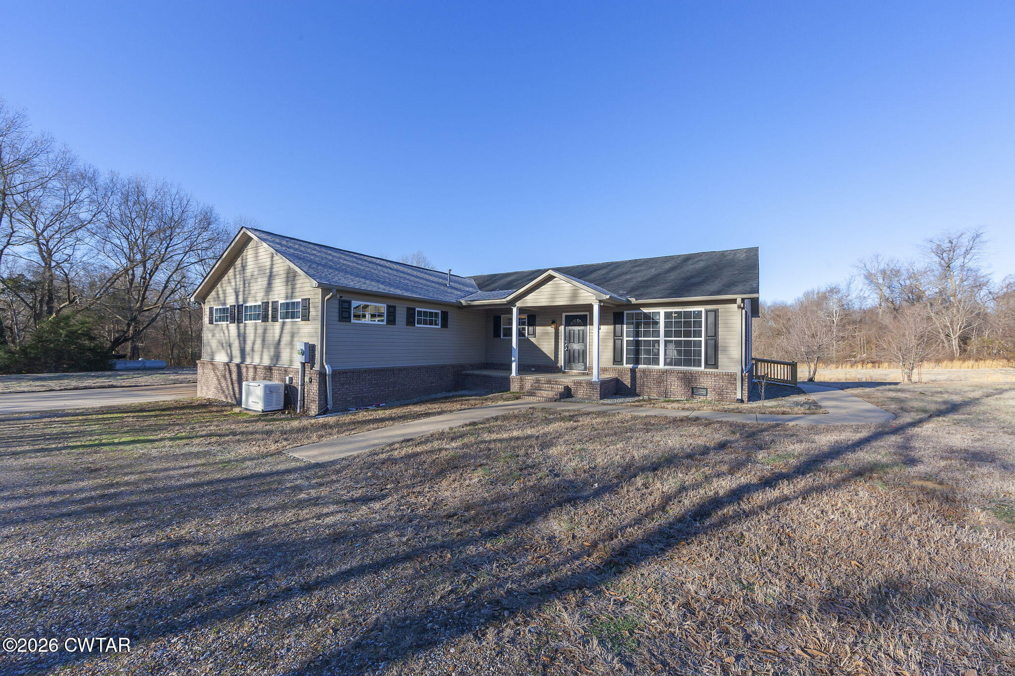 2265 Bond Ferry Road Brownsville, TN 38012 - Photo 26 of 26 a front view of a house with a yard and garage