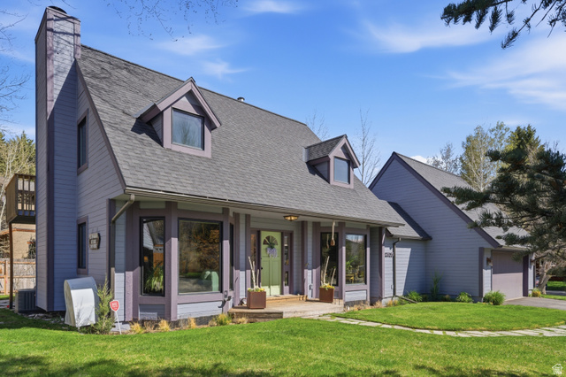 2635 Little Kate Road, Unit 21 Park City, UT 84060 - Photo 2 of 39 Cape cod-style house featuring a front yard, a porch, a chimney, roof with shingles, and a garage
