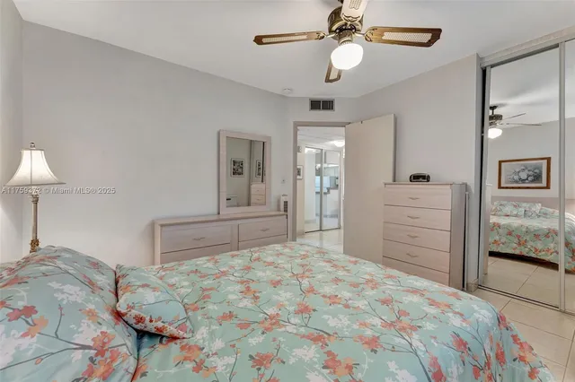 a bathroom with a toilet sink vanity and shower