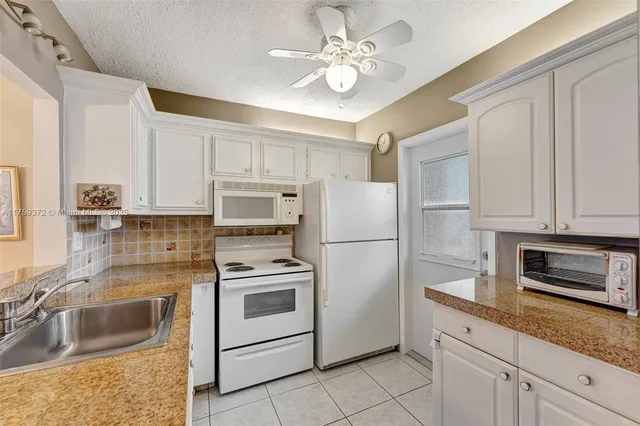 a kitchen with cabinets stainless steel appliances and a counter space