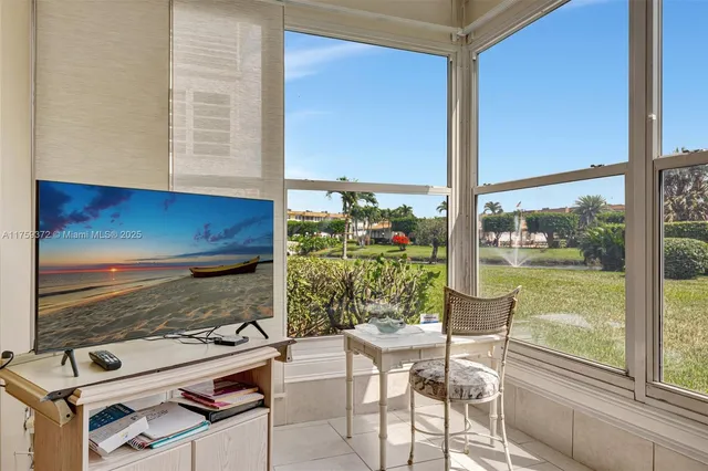a room with furniture and a floor to ceiling window