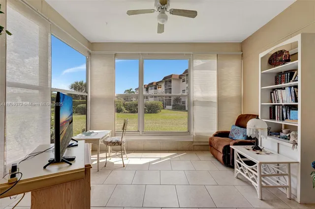 a work room with furniture and a floor to ceiling window