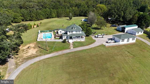 an aerial view of a house with a yard basket ball court
