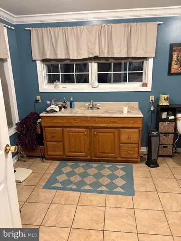 a living room with furniture a flat screen tv and a stove