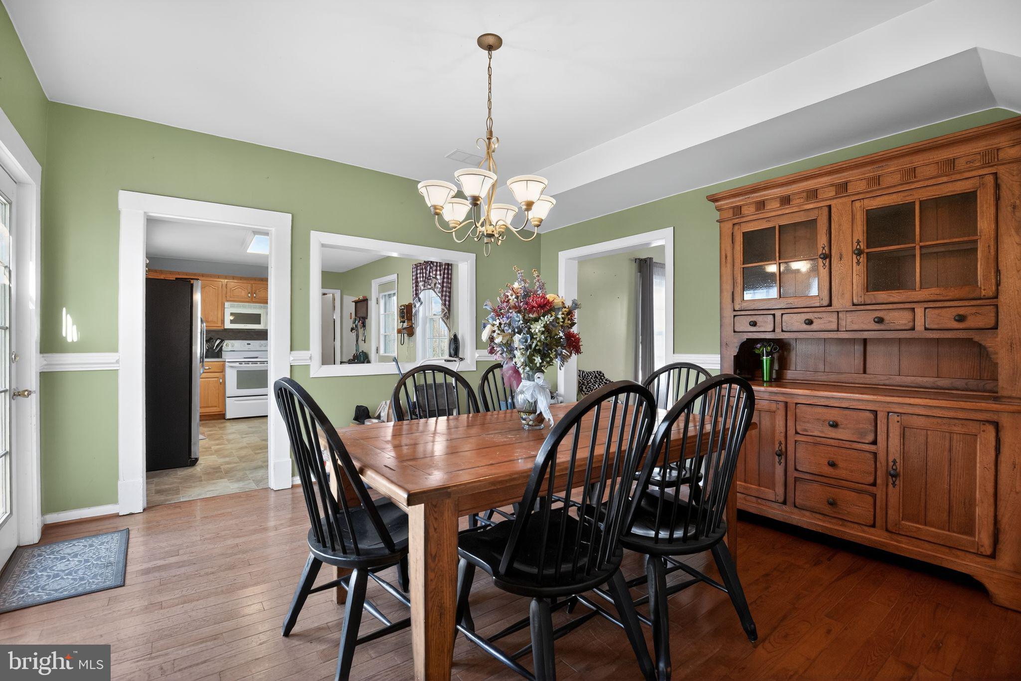 26669 Queentree Road Mechanicsville, MD 20659 - Photo 18 of 48 a view of a dining room with furniture window and wooden floor