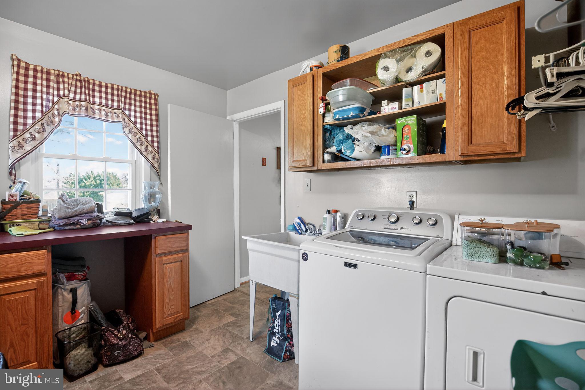 26669 Queentree Road Mechanicsville, MD 20659 - Photo 20 of 48 a kitchen with stainless steel appliances granite countertop a sink and a stove next to a window