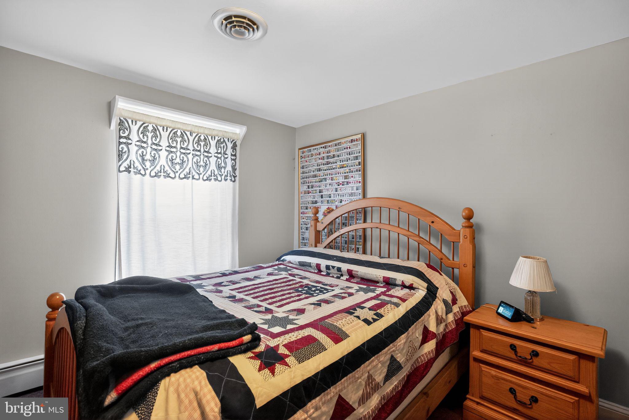 26669 Queentree Road Mechanicsville, MD 20659 - Photo 21 of 48 a bedroom with a bed and a window