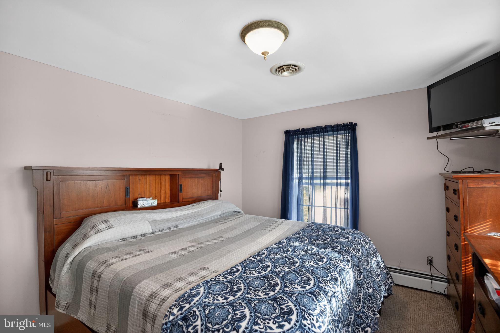 26669 Queentree Road Mechanicsville, MD 20659 - Photo 27 of 48 a bedroom with a bed and a flat screen tv