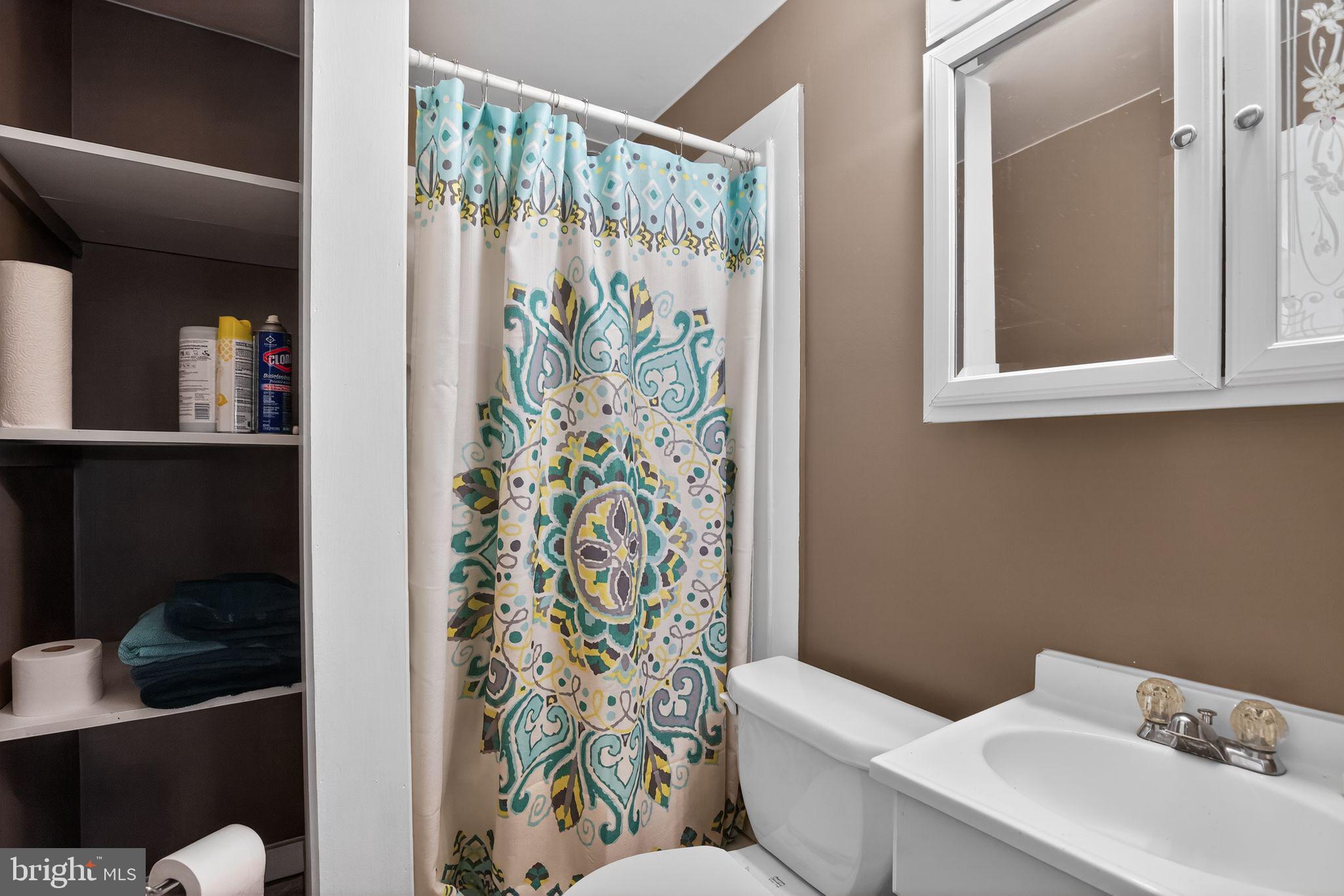 26669 Queentree Road Mechanicsville, MD 20659 - Photo 29 of 48 a bathroom with a toilet sink and shower curtain