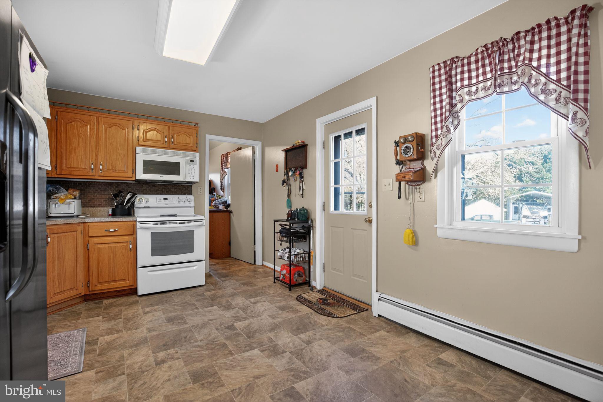26669 Queentree Road Mechanicsville, MD 20659 - Photo 30 of 48 a kitchen with a refrigerator and a stove
