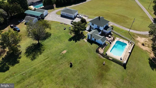 an aerial view of residential houses with outdoor space and swimming pool