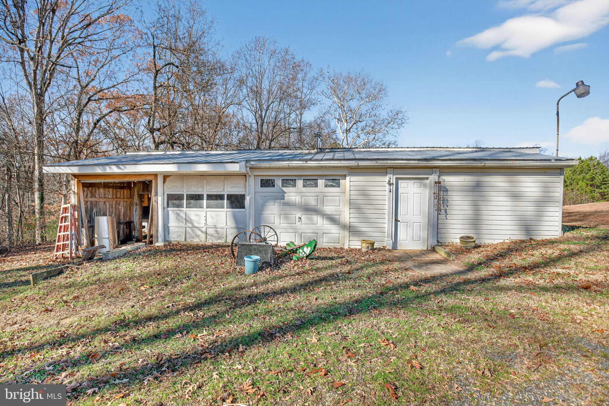 26669 Queentree Road Mechanicsville, MD 20659 - Photo 33 of 48 a front view of a house with a garden and patio