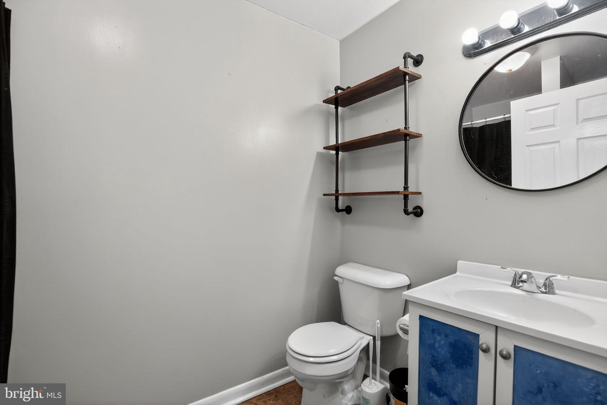 26669 Queentree Road Mechanicsville, MD 20659 - Photo 38 of 48 a bathroom with a sink a toilet and a mirror