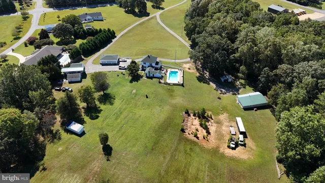 an aerial view of a residential houses with yard