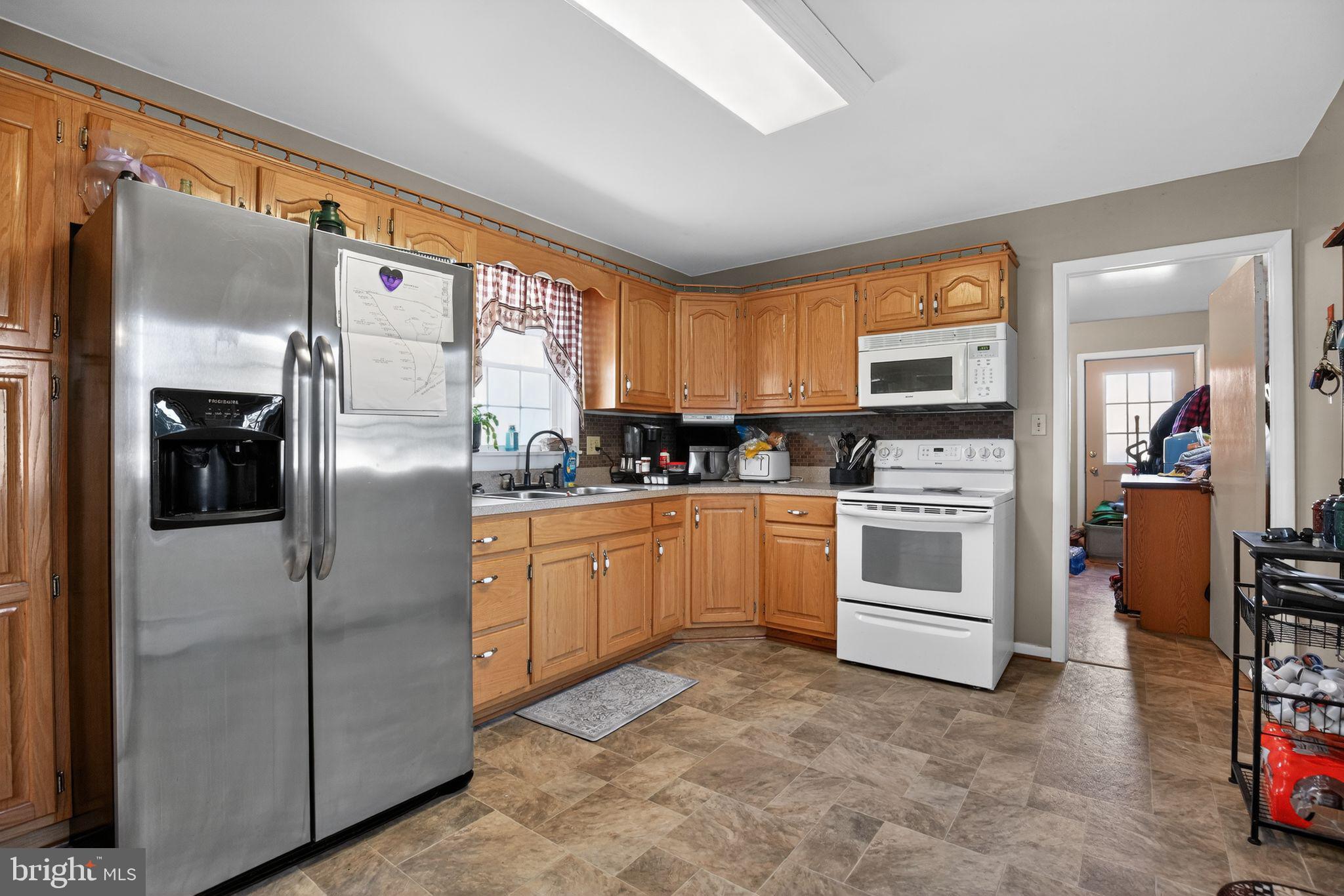 26669 Queentree Road Mechanicsville, MD 20659 - Photo 43 of 48 a kitchen with cabinets and stainless steel appliances