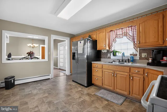 a kitchen with stainless steel appliances granite countertop a refrigerator stove and sink