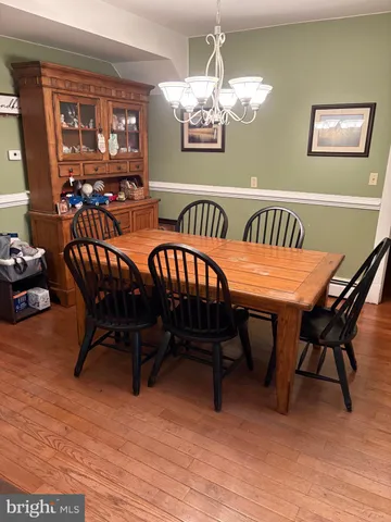 a dining room with furniture a rug and wooden floor