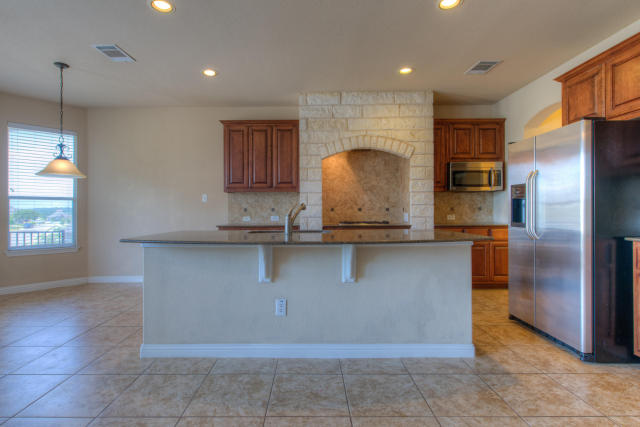 321 Limestone Trail Austin, TX 78737 - Photo 18 of 28 a kitchen with stainless steel appliances granite countertop a refrigerator and a sink
