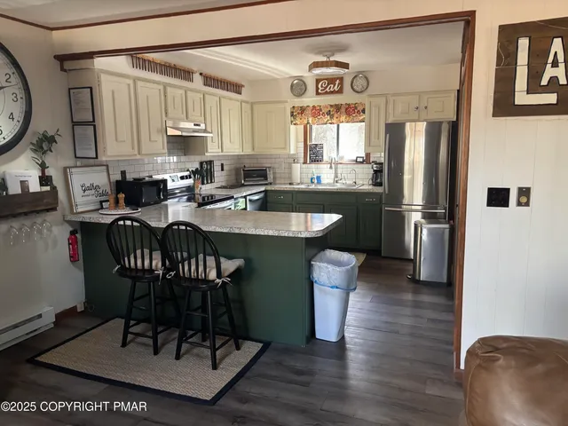 a kitchen with a dining table and chairs