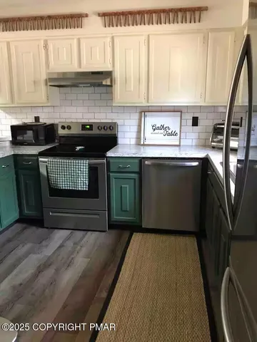 a living room with furniture a fireplace and a large window