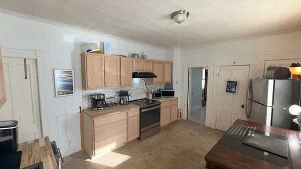 a kitchen with stainless steel appliances granite countertop a refrigerator stove and sink