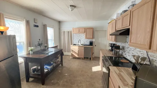 a kitchen with a sink appliances and cabinets