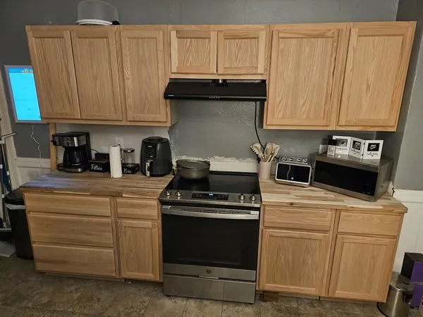 a kitchen with granite countertop cabinets and steel stainless steel appliances