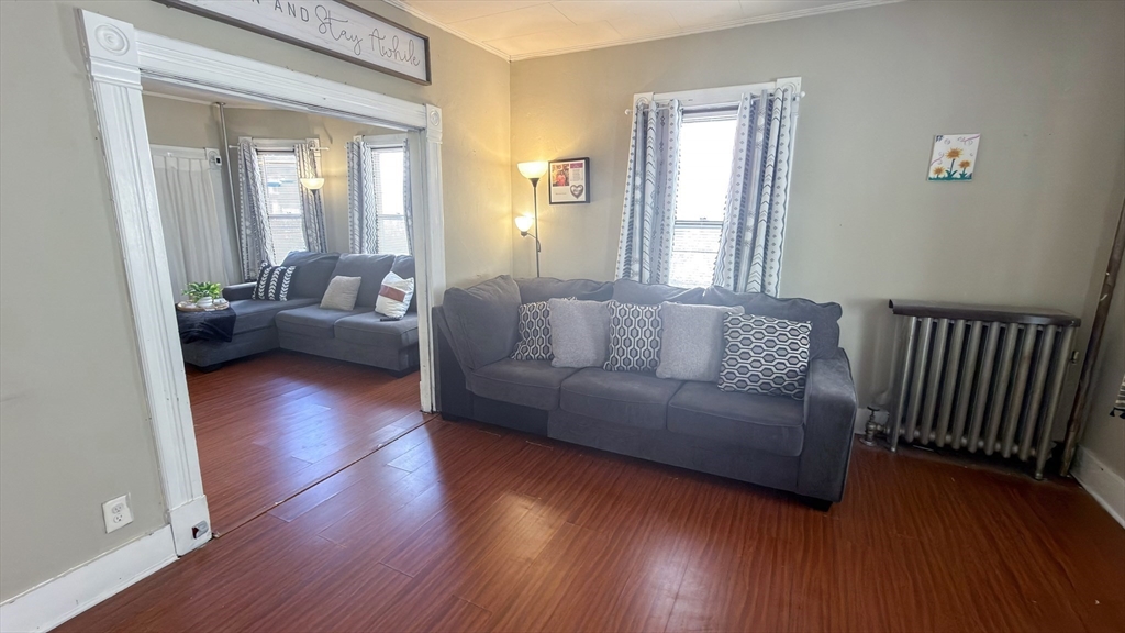 24 Hampden Street West Springfield, MA 01089 - Photo 6 of 18 a living room with couches and a potted plant next to a window