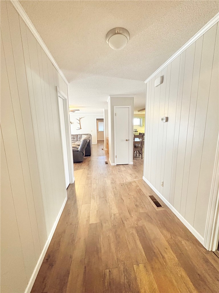 1404 Farrs Bridge Road Easley, SC 29640 - Photo 18 of 27 This interior hallway features warm flooring and classic white trim for a welcoming atmosphere.