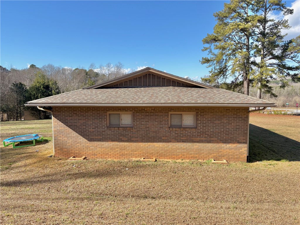 1404 Farrs Bridge Road Easley, SC 29640 - Photo 19 of 27 This brick structure features a classic roof, blending with the natural surroundings.