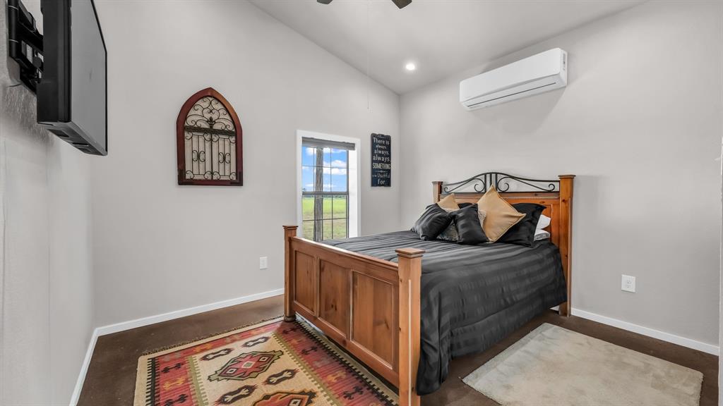 3810 Fairview Road Millsap, TX 76066 - Photo 14 of 25 Bedroom with an AC wall unit, a ceiling fan, recessed lighting, and lofted ceiling