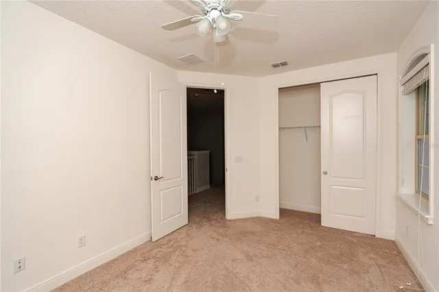 an empty room with closet and entryway