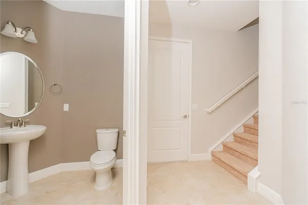 a room with a wooden floor and cabinets