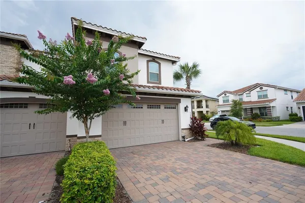 a front view of house with a garden
