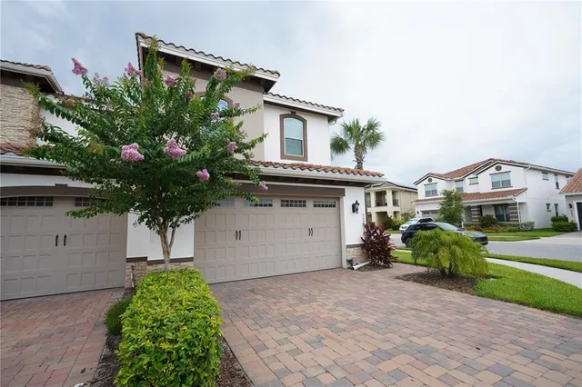 a front view of house with a garden