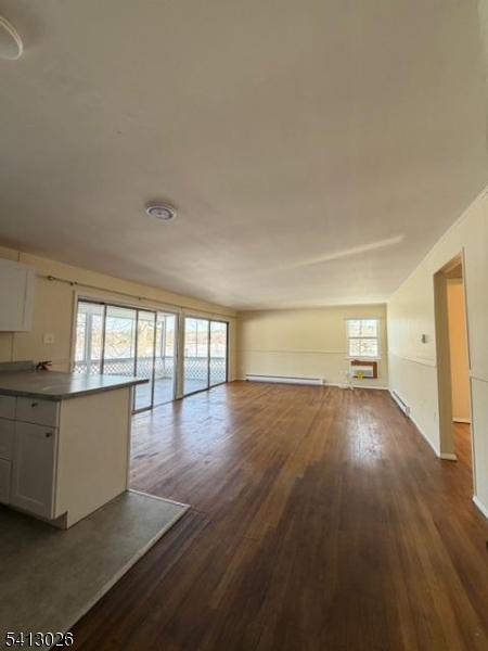 113 D North Shore Point Montague, NJ 07827 - Photo 3 of 18 a view of an empty room with wooden floor and a window