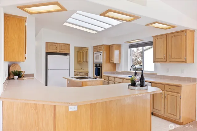 a kitchen that has a sink and a stove in it