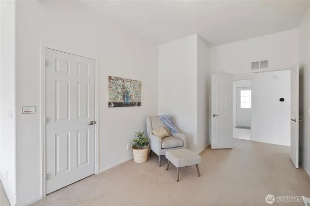 a bedroom with a large bed and a large window