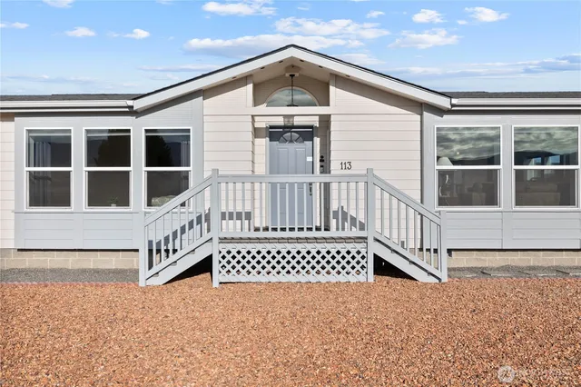 a view of a wooden house with large windows