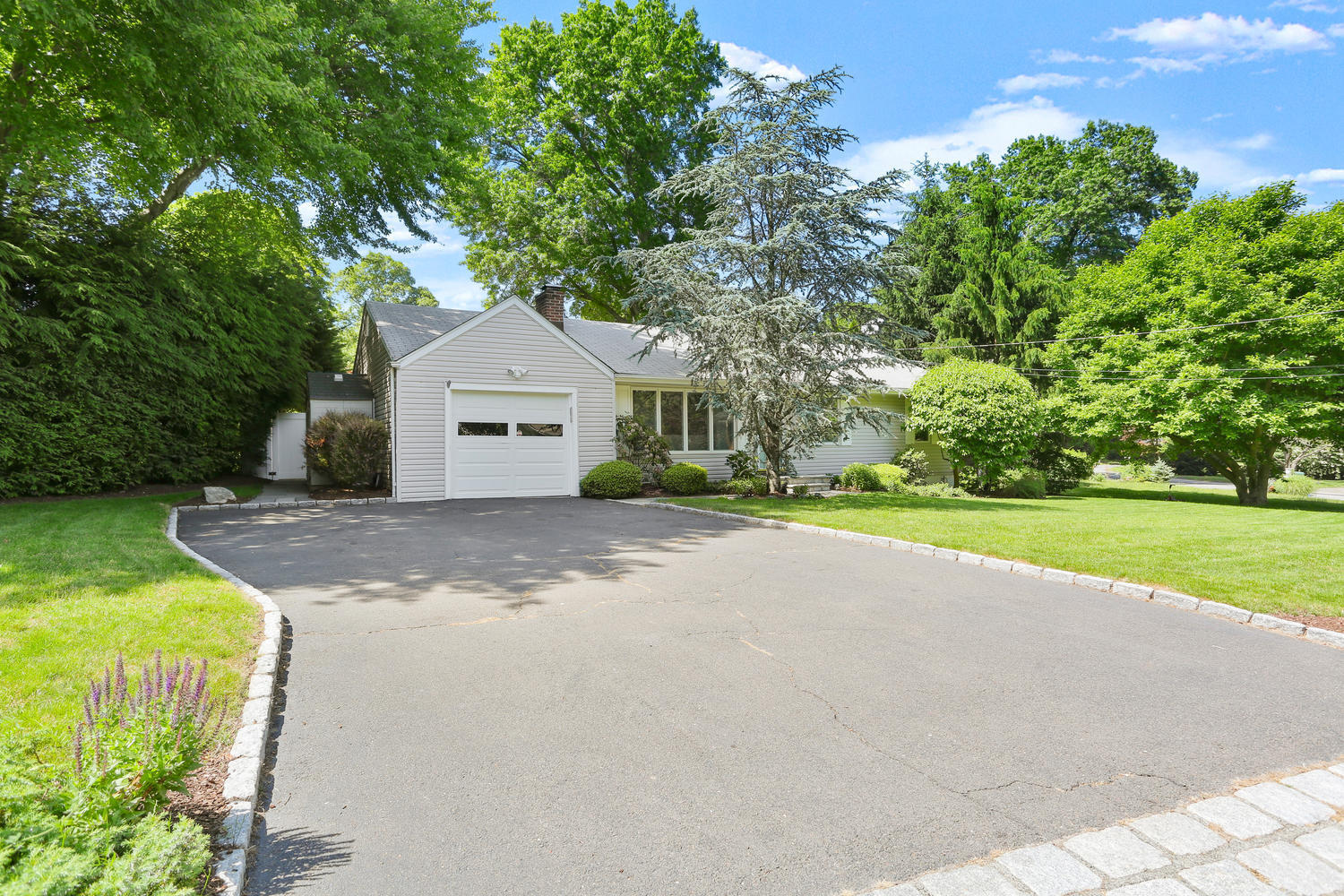 12 Powder Horn Road Norwalk, CT 06850 - Photo 22 of 24 a front view of a house with a yard and garage