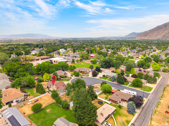 1279 West 1500th Street North Mapleton, UT 84664 - Photo 79 of 83 Aerial perspective of a residential neighborhood with mountain backdrop