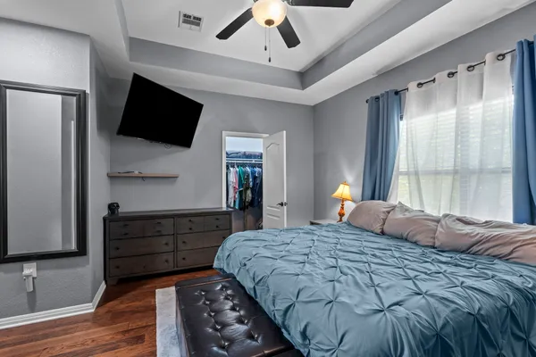 a bedroom with a bed and a television