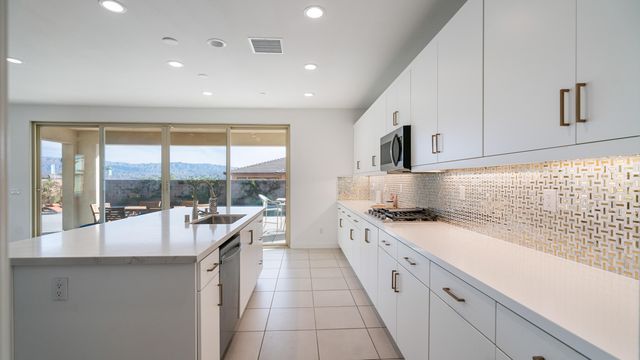 a large white kitchen with a large window