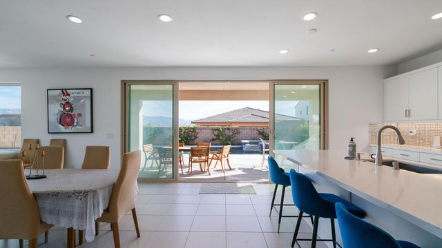 a dining room with furniture a window and a flat screen tv