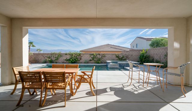 a view of a patio with table and chairs potted plants