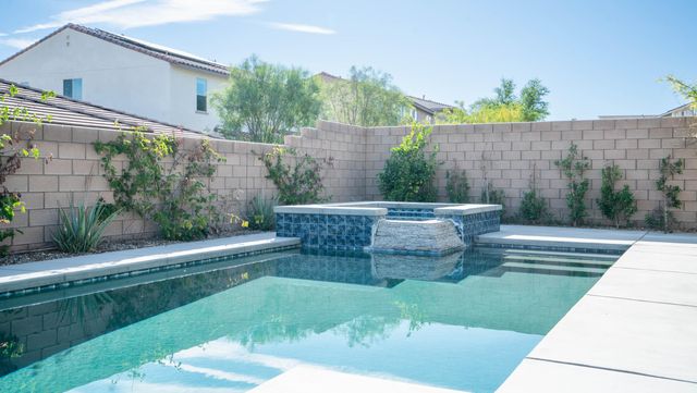 a view of swimming pool with outdoor seating and plants