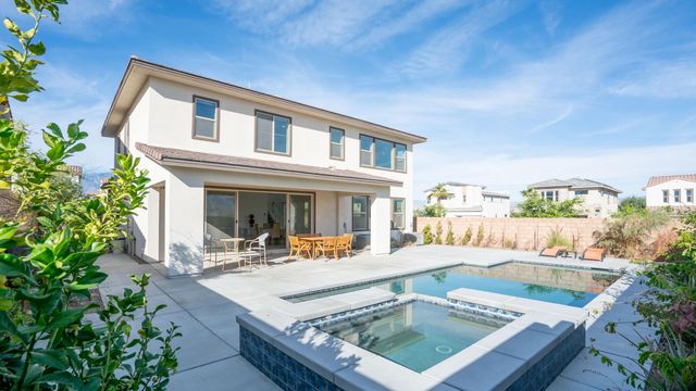 a view of a patio with couches and table and chairs and potted plants