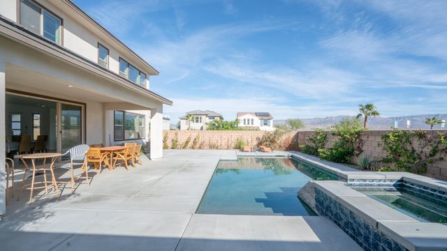 a view of a patio with couches and table and chairs and potted plants